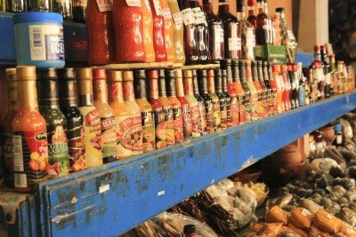 Colorful bottles on a blue shop shelf in St. Lucia