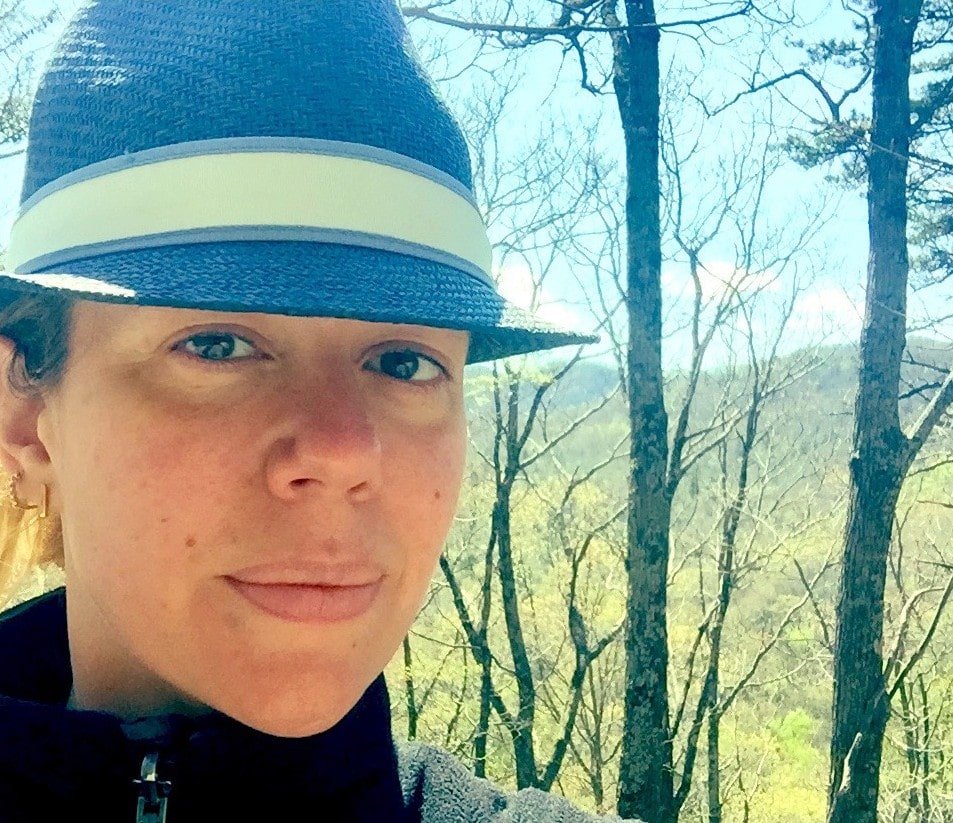 A selfie of me with the mountains behind me in the distance