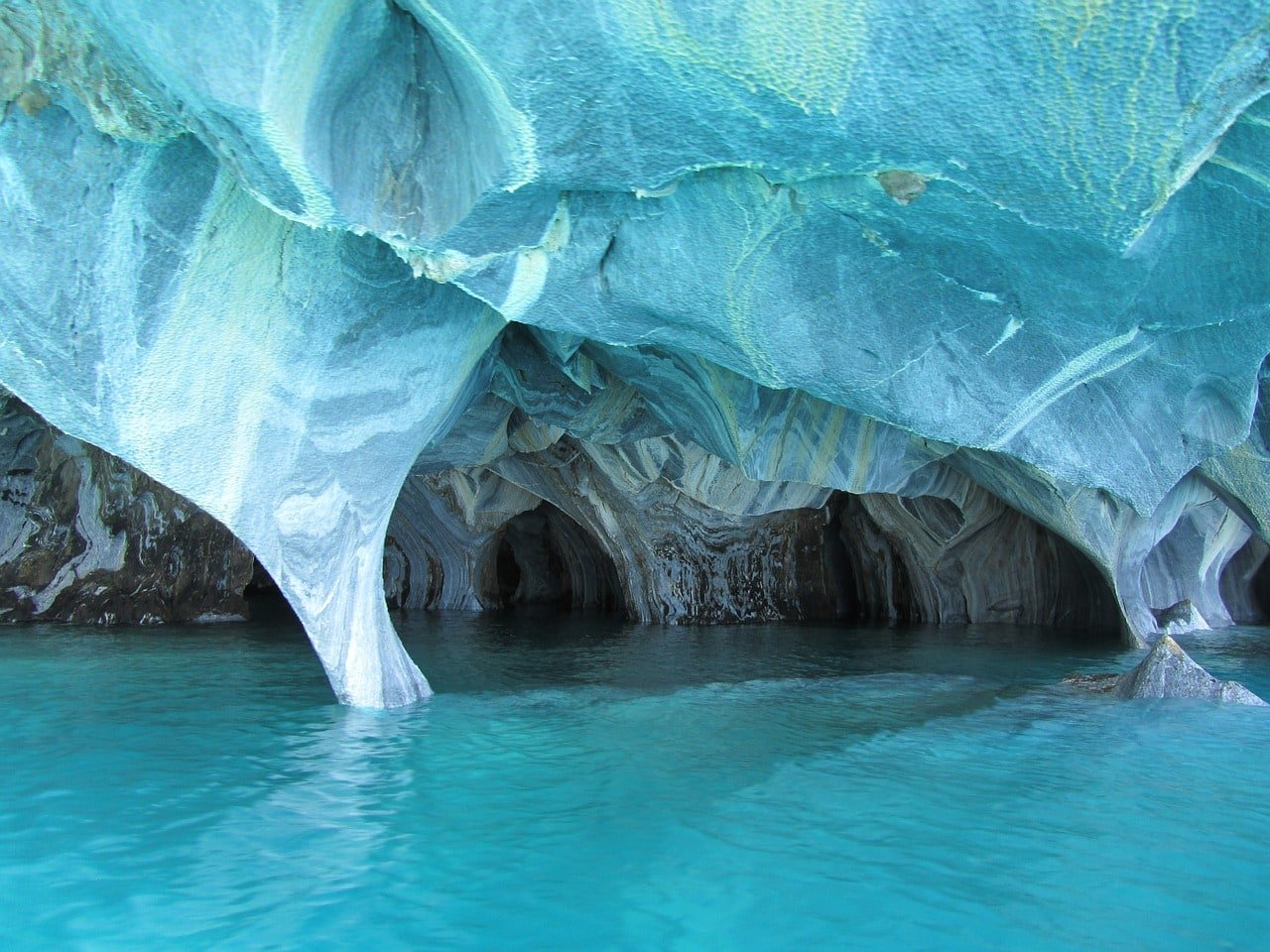 Alt Text: Image of a blue cave, semi-underwater.
