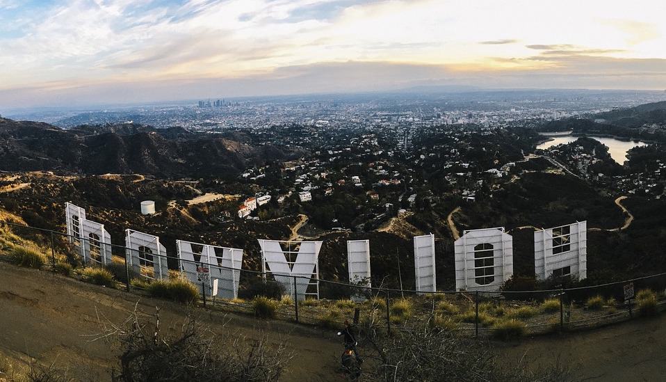 Alt Text: A fisheye photograph of the Hollywood sign from the back at sunset.